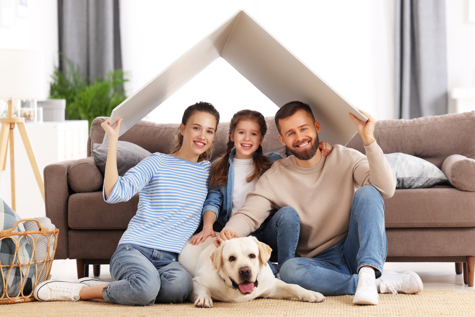 Happy family with dog enjoying new home